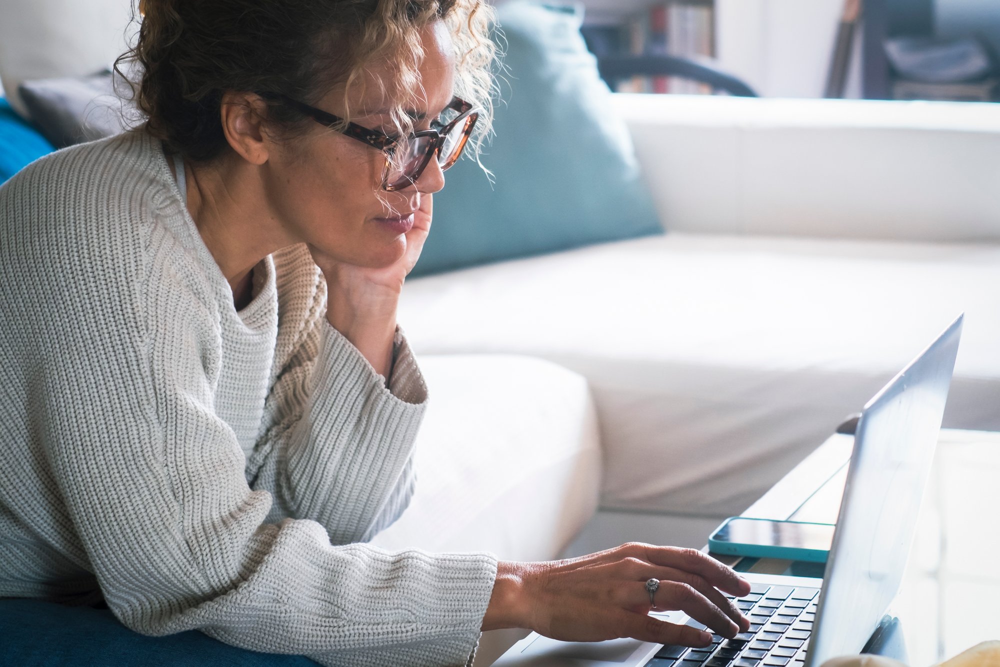 relax-typing-and-woman-on-a-couch-laptop-and-sea-2025-03-06-12-04-47-utc